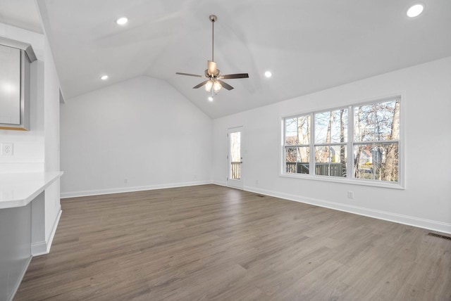 unfurnished living room featuring ceiling fan, dark hardwood / wood-style flooring, and lofted ceiling