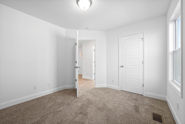 unfurnished bedroom with carpet floors and a closet