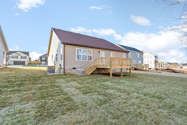 back of house with central AC, a deck, and a yard