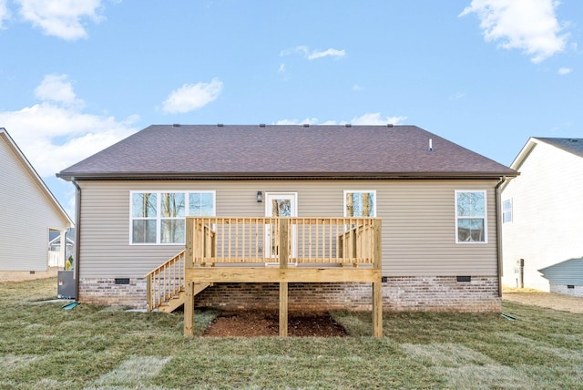 rear view of property with a deck and a yard