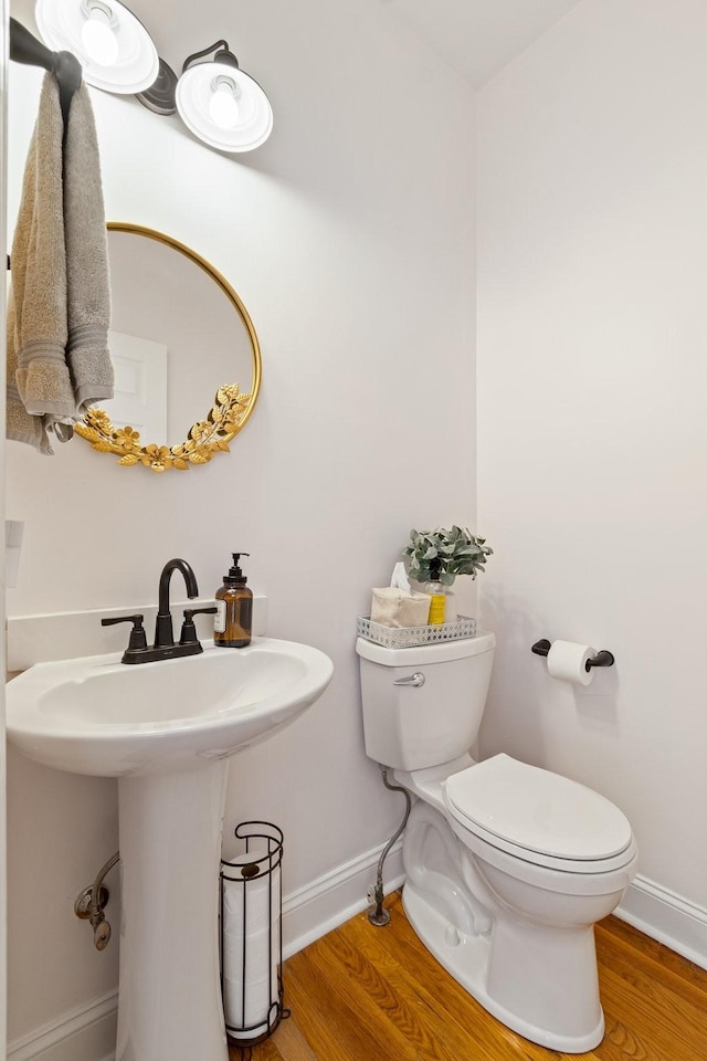 bathroom with sink, toilet, and hardwood / wood-style floors