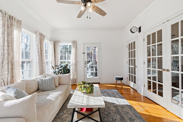 sunroom with ceiling fan and french doors