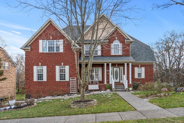 view of property featuring a front lawn