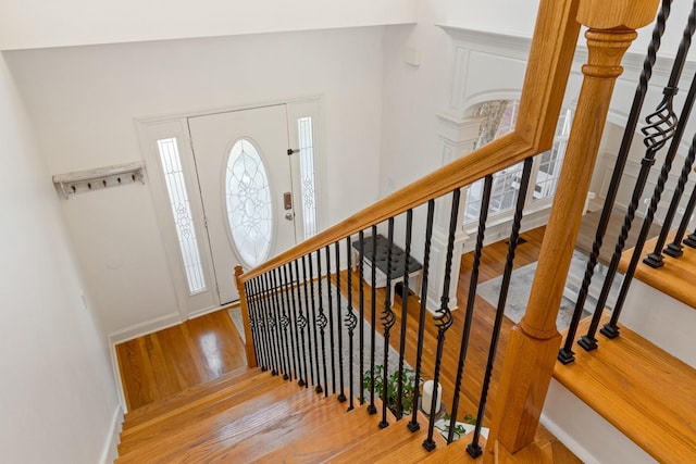 entryway with vaulted ceiling and wood-type flooring