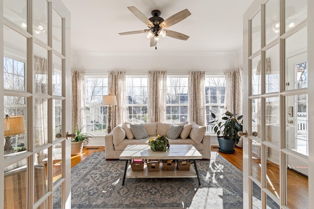 sunroom / solarium featuring ceiling fan and plenty of natural light