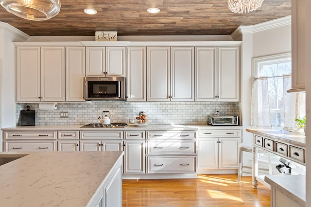 kitchen featuring stainless steel appliances, light stone countertops, wooden ceiling, and tasteful backsplash