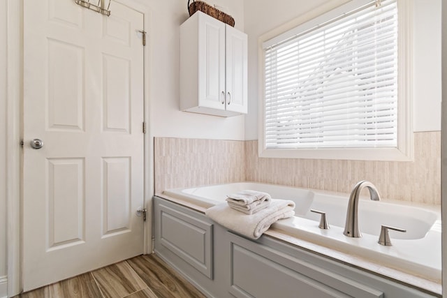 bathroom with a bath and wood-type flooring