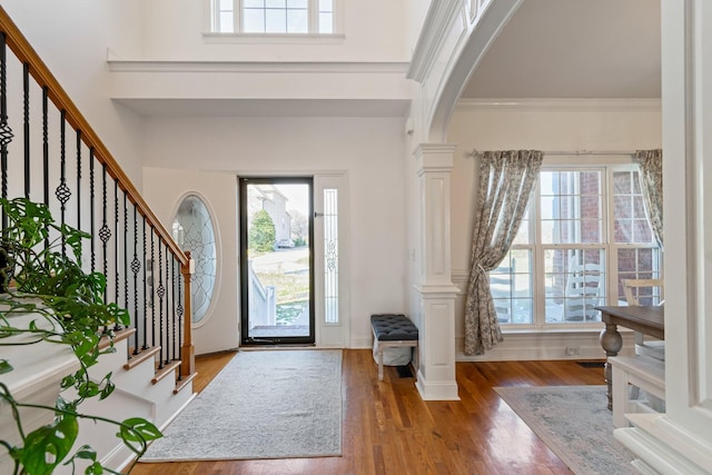 entryway with hardwood / wood-style flooring and ornamental molding