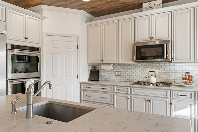 kitchen with sink, light stone counters, appliances with stainless steel finishes, and wood ceiling