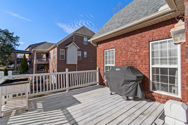 wooden deck featuring a grill