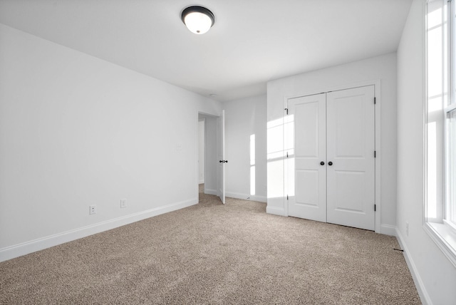 unfurnished bedroom with carpet and a closet