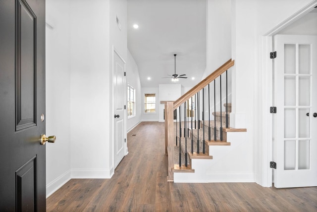 foyer entrance with ceiling fan and dark hardwood / wood-style flooring