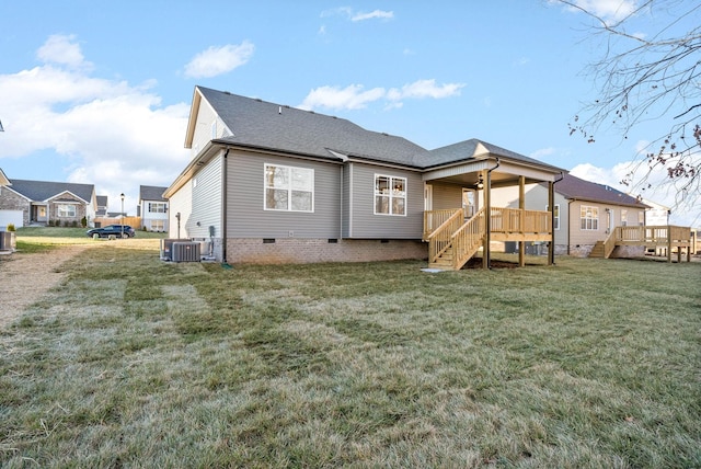 back of property featuring a deck and a yard