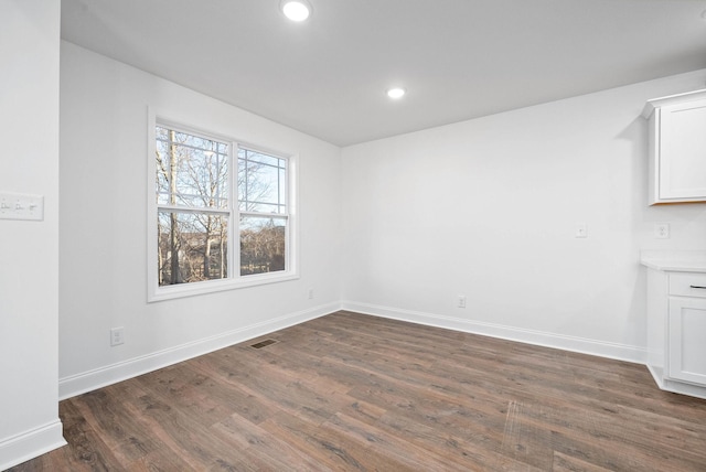 unfurnished dining area with dark hardwood / wood-style floors