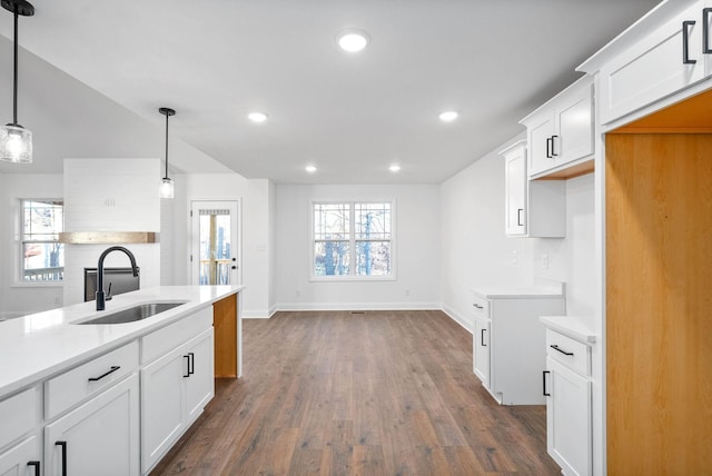 kitchen featuring white cabinetry, pendant lighting, dark hardwood / wood-style floors, and sink