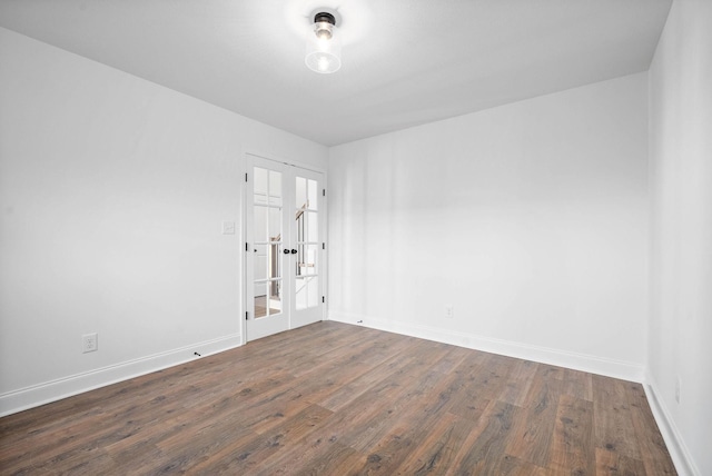 spare room with dark hardwood / wood-style floors and french doors