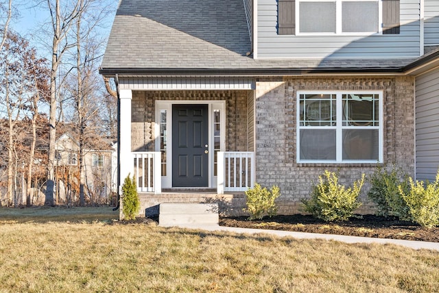 doorway to property with a lawn