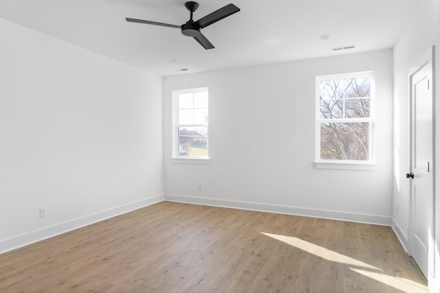 spare room with light wood-type flooring and ceiling fan