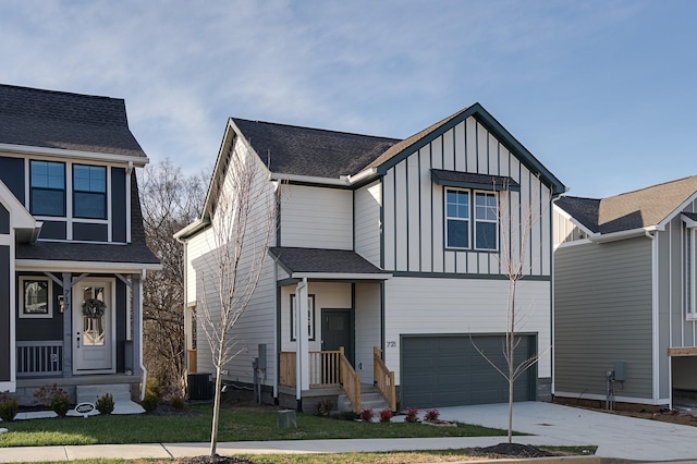 view of front of home with central AC and a garage