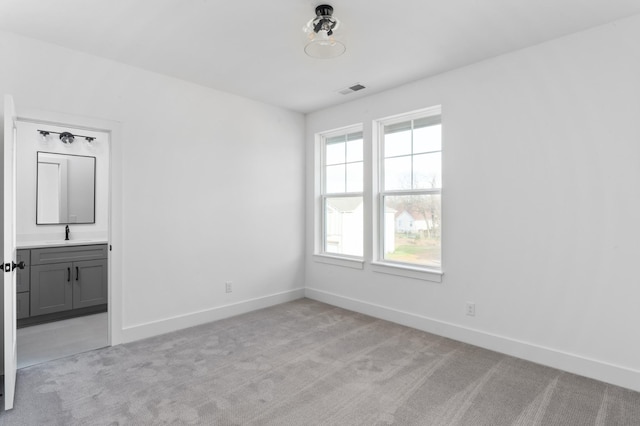 carpeted spare room featuring sink