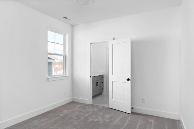 unfurnished bedroom featuring light colored carpet