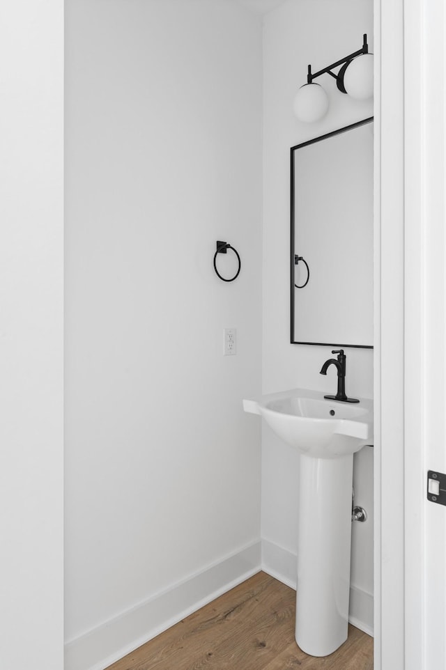 bathroom with hardwood / wood-style flooring