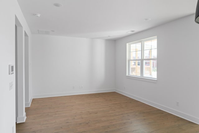 unfurnished room featuring hardwood / wood-style flooring