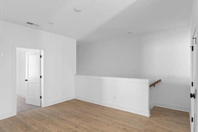 unfurnished room with hardwood / wood-style floors