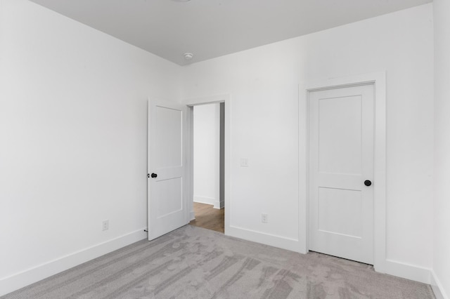 unfurnished bedroom with light colored carpet