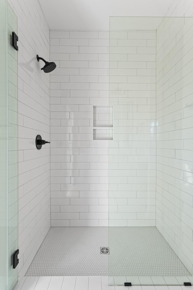 bathroom featuring an enclosed shower and tile patterned flooring