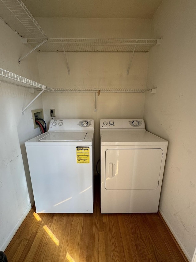 washroom featuring washing machine and dryer and hardwood / wood-style floors