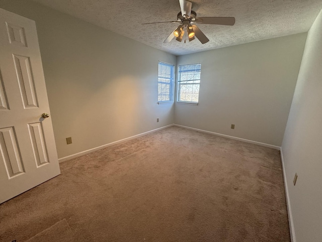 carpeted empty room featuring a textured ceiling and ceiling fan