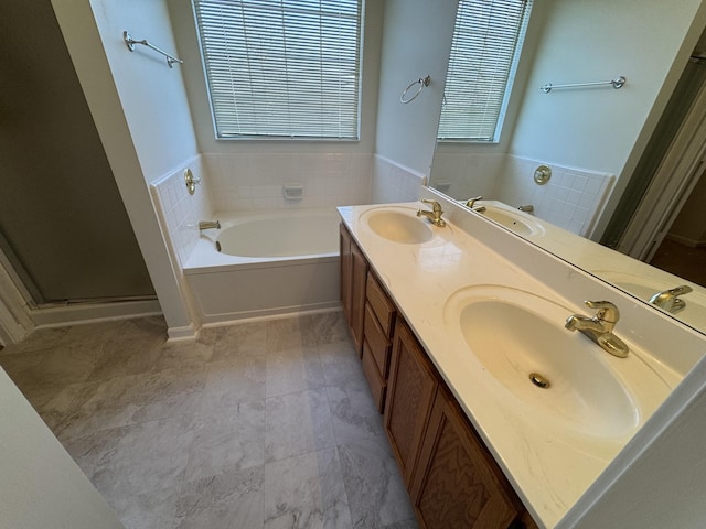 bathroom featuring vanity and separate shower and tub