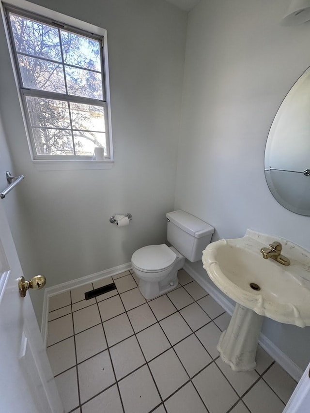 bathroom featuring toilet, tile patterned floors, and sink