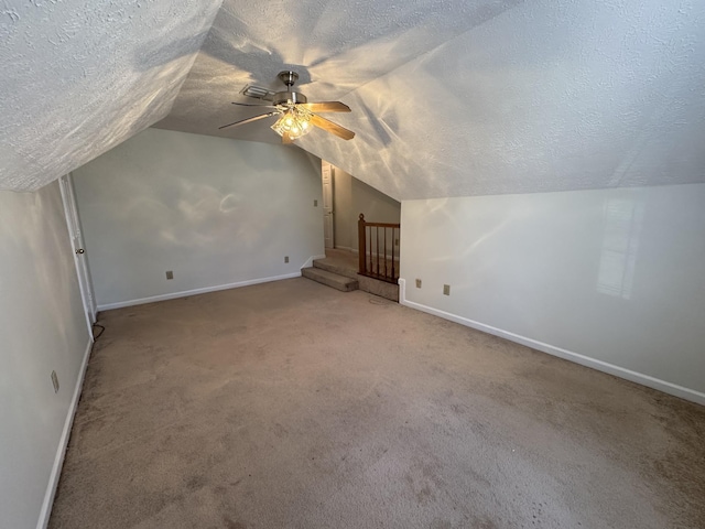 bonus room featuring a textured ceiling, ceiling fan, carpet, and lofted ceiling