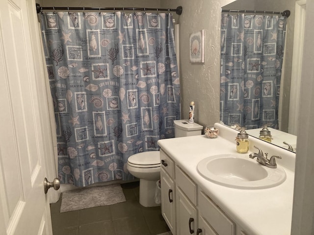 bathroom featuring toilet, vanity, tile patterned flooring, and a shower with shower curtain