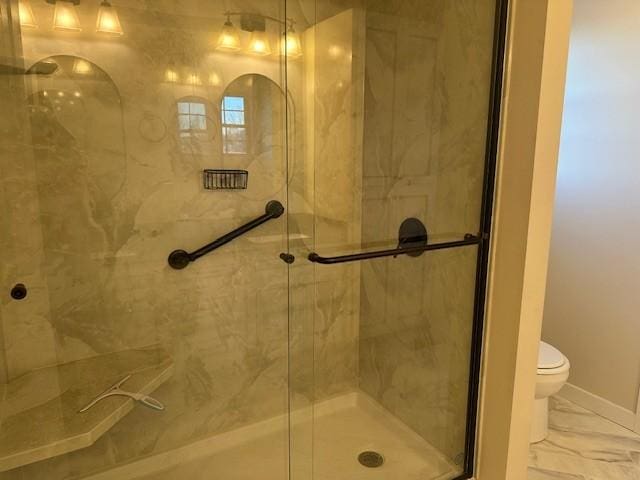 bathroom with an enclosed shower and toilet