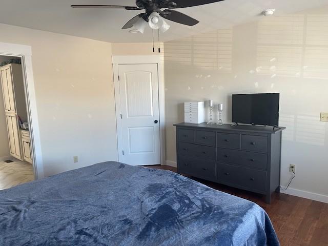 bedroom featuring ceiling fan and dark wood-type flooring