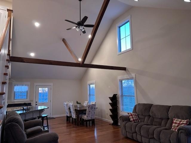 living room with ceiling fan, dark hardwood / wood-style floors, beamed ceiling, and high vaulted ceiling