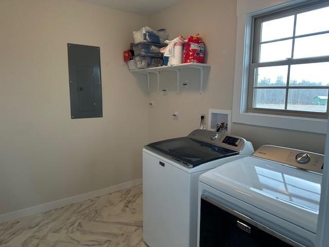 clothes washing area featuring plenty of natural light, electric panel, and washing machine and clothes dryer