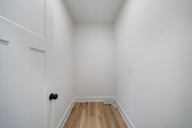 clothes washing area featuring light hardwood / wood-style flooring