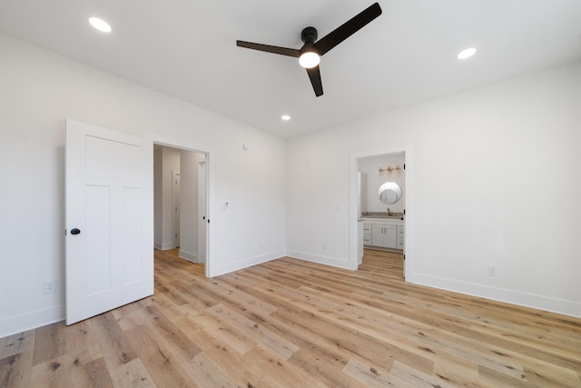 unfurnished bedroom featuring ceiling fan, light hardwood / wood-style floors, and ensuite bath