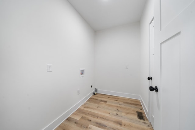 laundry area featuring washer hookup and light hardwood / wood-style flooring