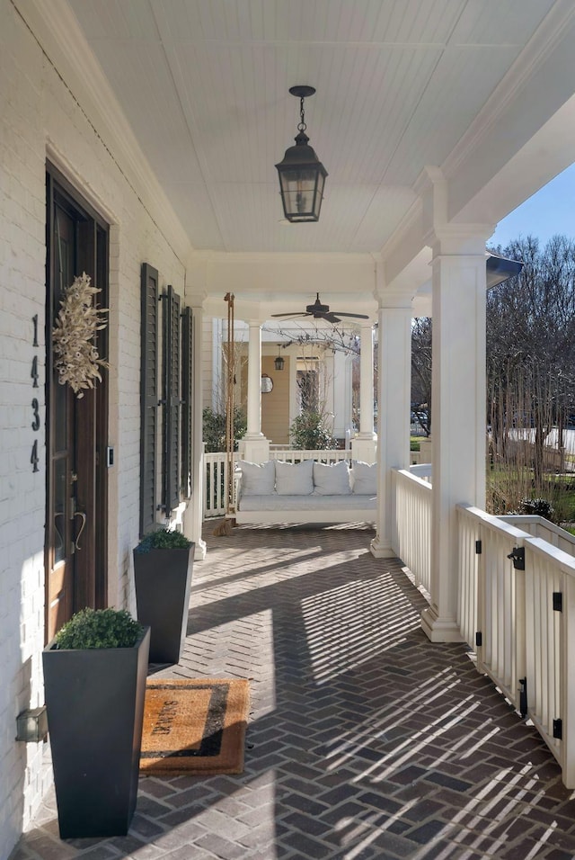 view of patio featuring ceiling fan and a porch