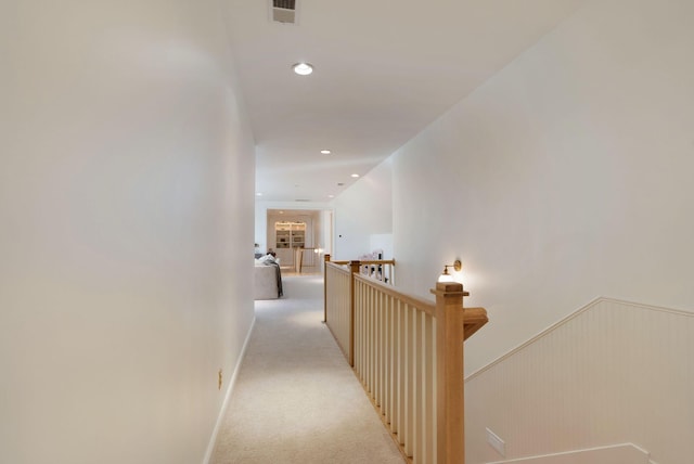 hallway featuring light colored carpet