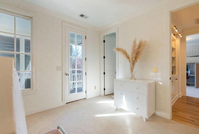 doorway to outside with ornamental molding, light colored carpet, and built in shelves