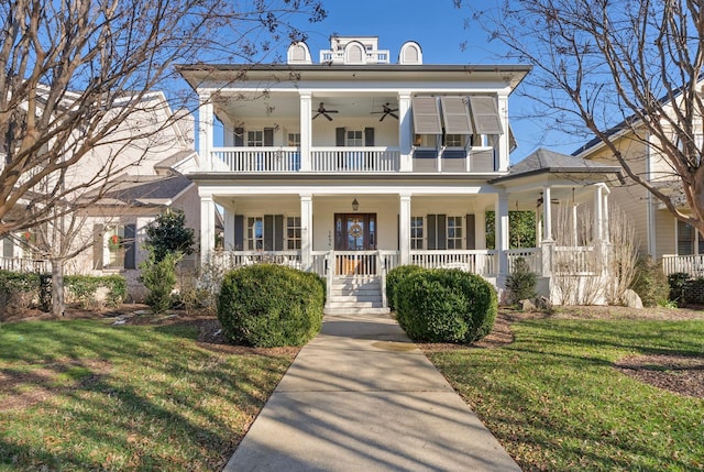 view of front of home with a balcony, a porch, and a front yard