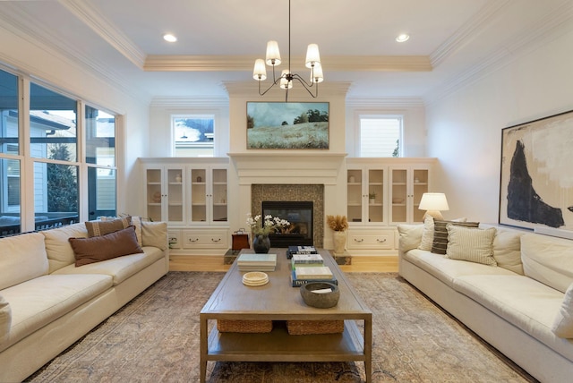 living room with light hardwood / wood-style flooring, a notable chandelier, and a healthy amount of sunlight