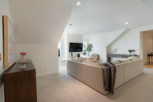 carpeted living room featuring vaulted ceiling