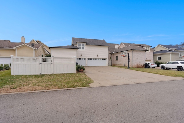 view of front of home with a front lawn and a garage